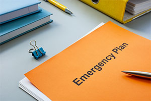 PIcture of desk with an emergency plan placed on top.